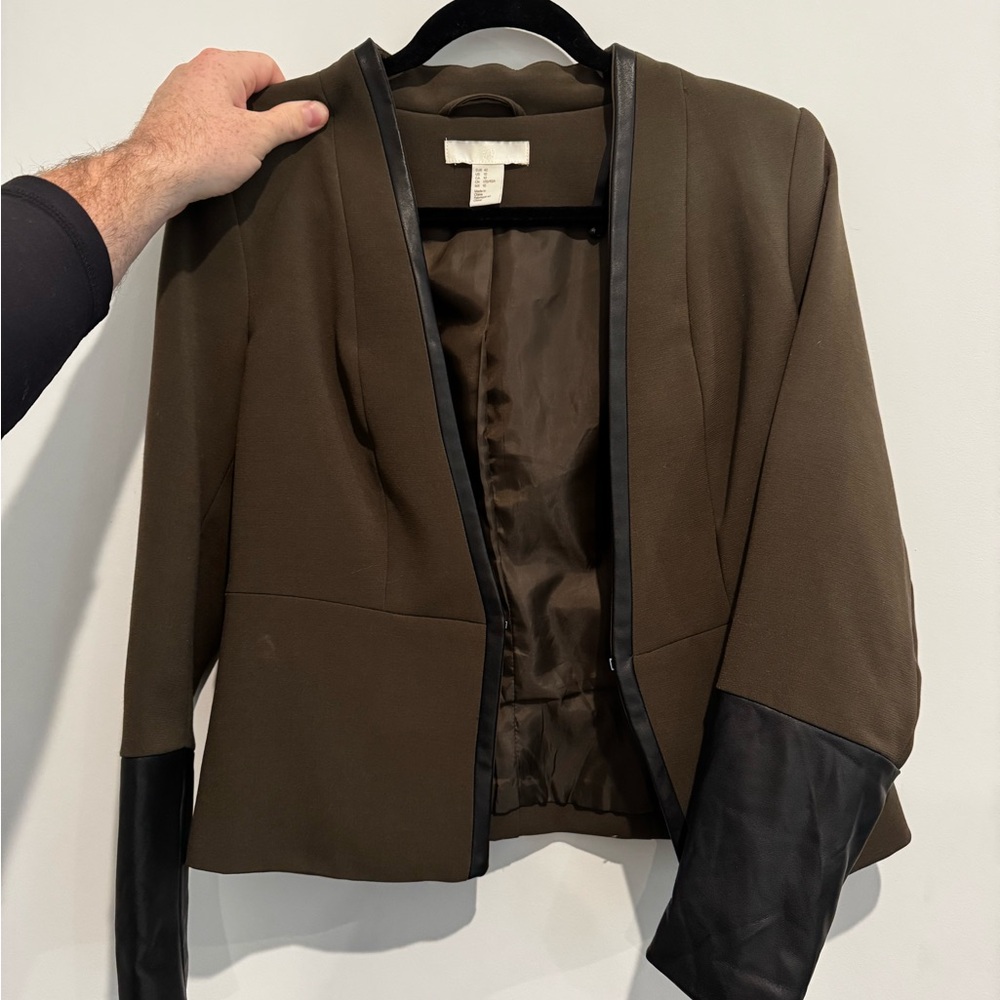 Green blazer with leather accent on trim and sleeves.